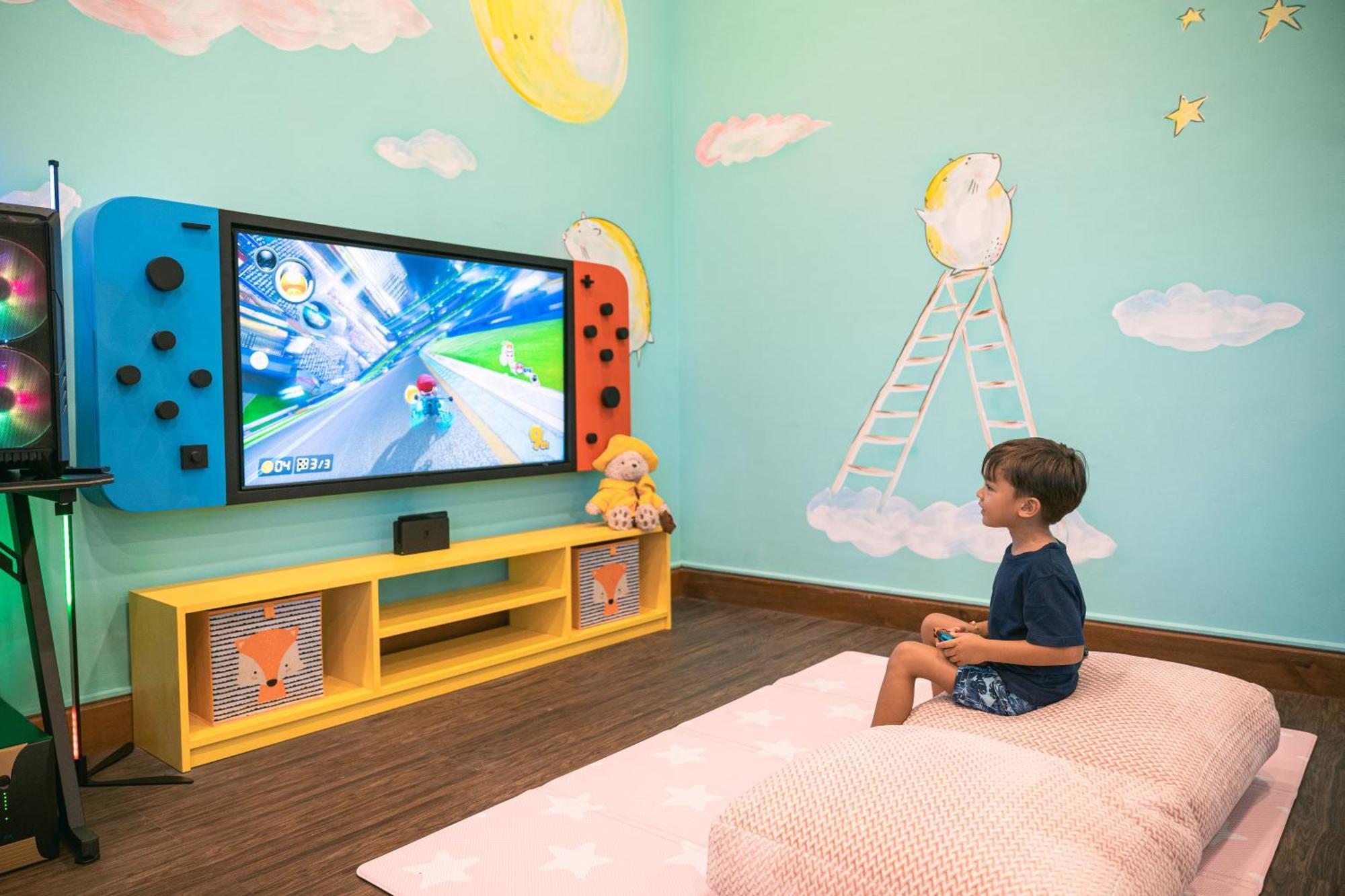 Bali Mandira Beach Resort & Spa Legian Dış mekan fotoğraf A child playing Mario Kart 8 Deluxe on a Nintendo Switch
